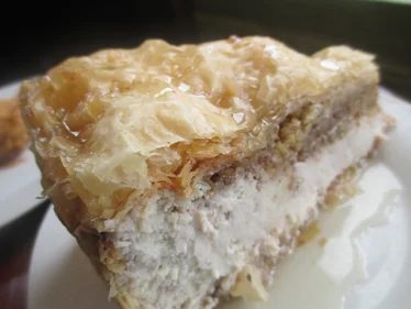 A slice of layered filo pastry with a cream filling